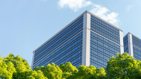 Eco-friendly building in modern city Sustainable glass office building with trees to reduce CO2 Green architecture Eco-friendly building Corporate sustainabilityの写真素材
