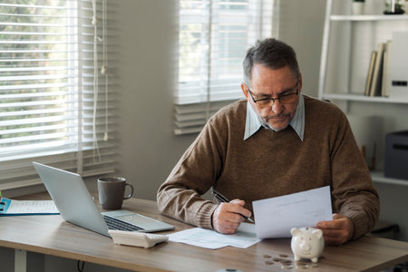 Retired old man is calculating stress about annual tax, debt, arrears in the house. Tax concept.