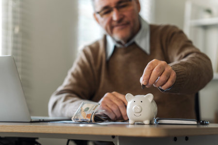 Retirement Saving Investment, Old Man Putting Coins in Piggy Bank, Retirement Planning Conceptの写真素材