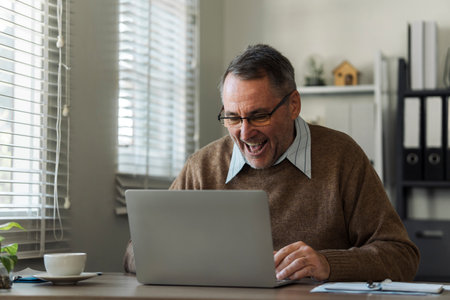 Retired senior man talking to taxman online about annual tax. Tax concept.