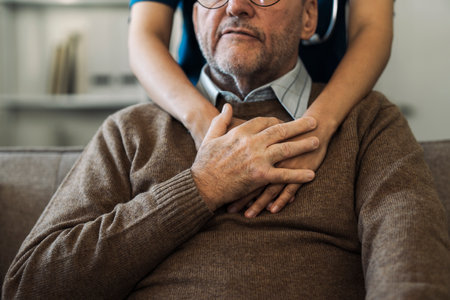 Caregiver encourages and hugs elderly man in nursing home care and confide in caregiverの写真素材