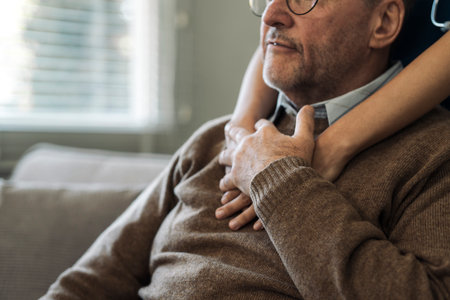 Caregiver encourages and hugs elderly man in nursing home care and confide in caregiverの写真素材