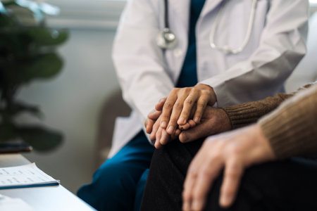 A female nurse caregiver holds hands to encourage and comfort an elderly woman. For care and trust...