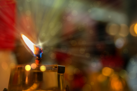 Oil lamp with bokeh and blurred background. Oil lamp burns brightly at shrine ,vegetarian festival, Phuketの写真素材