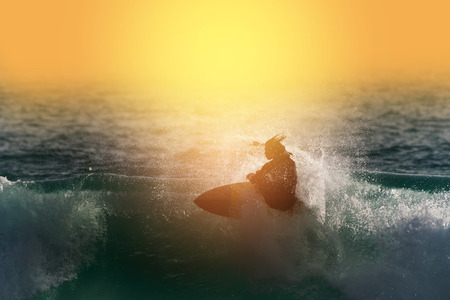 Surfing silhouette Happy surfer enjoy big wave and foam at sunset