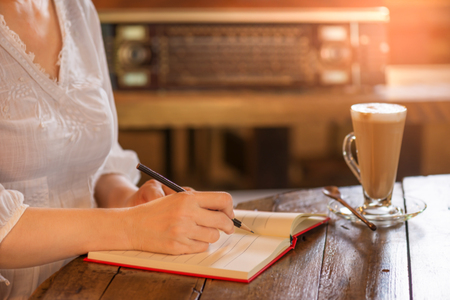 Working woman at vintage style coffee shop
 Start fresh new working day with tasty coffee,pencil and noteの写真素材