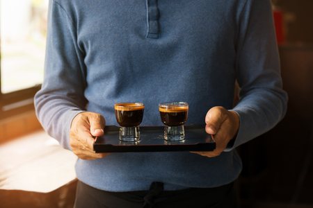 Barista serving espresso coffee
Young barista in vintage coffee shopの写真素材