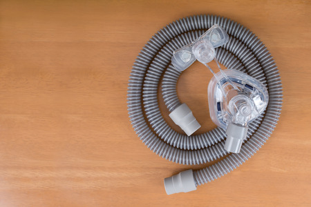 Pair of CPAP mask and tubing.Cleaning cpap mask and tubing is a routine job,flat lay.