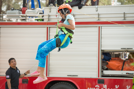 Phuket-January 14,2017:Zip-line for child  play on children day activity at Sapanhin park.
Brave children zip lining with happy smiling face from the truck top with fully security equipment.のeditorial素材