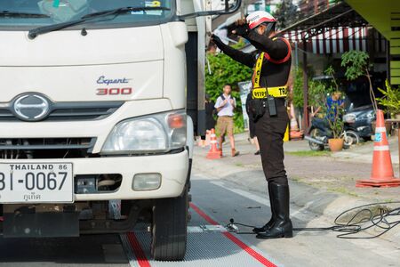 PHUKET-NOVEMBER 3,2016:Police set up portable wheel load scales for determining the weight of heavy...