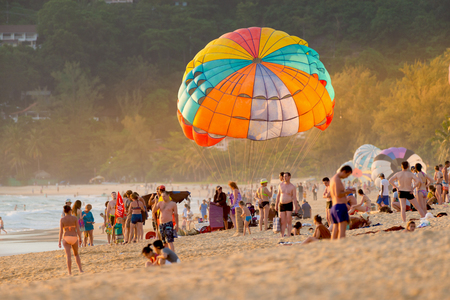 Phuket,Thailand - June 17,2017:Colorful parasails showing on tropical beach.
One of the most exciting activity over the beach,parasailing  stand by in between crowd of tourists at sunset,selected focus.のeditorial素材