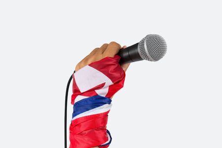 North Korea spokesman said.
 Hand with flag wristband holding microphone,isolated white background.の写真素材