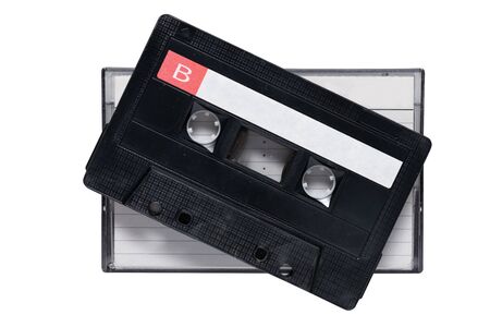 Black cassette tape  side B  laying on box with line white paper cover isolated on white background with clipping path. Cassette tape and box,top view.の写真素材