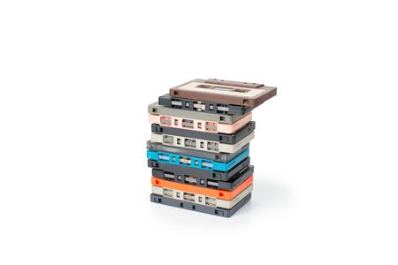 Obsolete technology of audio recording and playback format audio cassette tape isolated on white background with clipping path. Cassette tapes stack tower .の写真素材