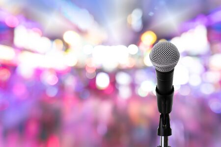 Close up of dynamic microphone setting on stand with colorful light bokeh background ,celebration event .Microphone on stage .の写真素材