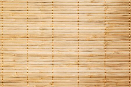 Bamboo sticks table mate binding with golden thread used for texture and background,top view. Bamboo mat,horizontal.の写真素材