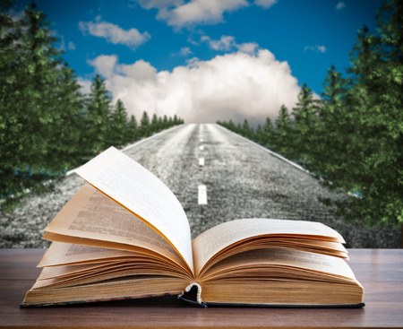 An open book on the background of the old roadの写真素材