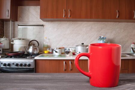 wooden surface and mug on the background of the kitchenの写真素材