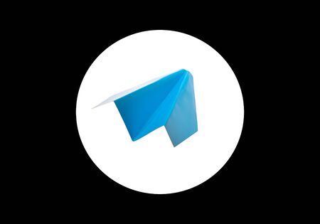 Blue paper airplane in a white circle on a black backgroundの写真素材