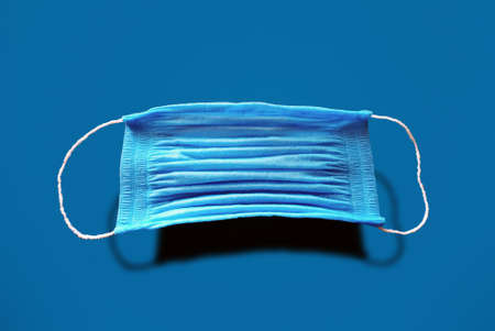 medical face mask on a blue background, coronavirus conceptの写真素材