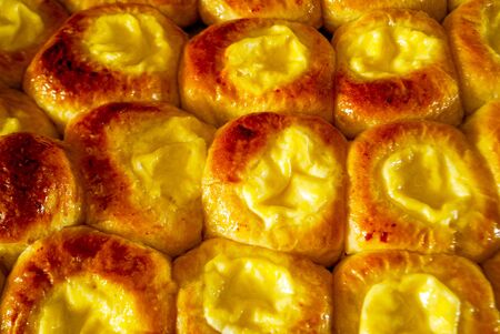 Close-up buns with cottage cheese on a baking sheetの写真素材