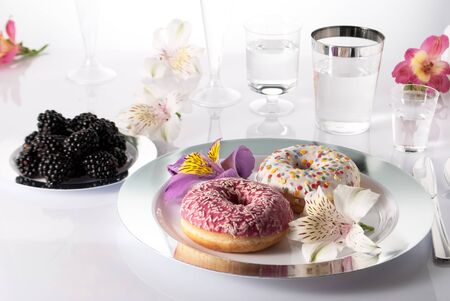donuts in a plate on the tableの写真素材