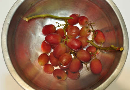 Closeup of red grape in a water bowlの写真素材