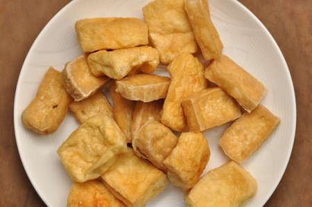 Fried tofu on white plate, closeup of fried tofu on the table, table top view, directly aboveの写真素材