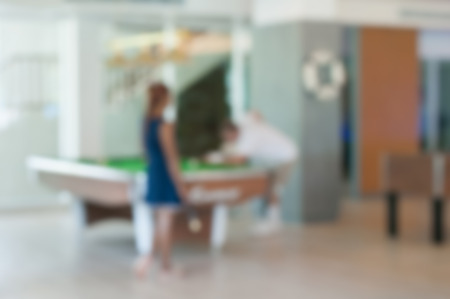 Image Blur Young people playing billiard in a sport club.