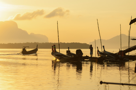 Landscape of andaman long tailed boat southern of thailand floating on sea water with sun shineの写真素材