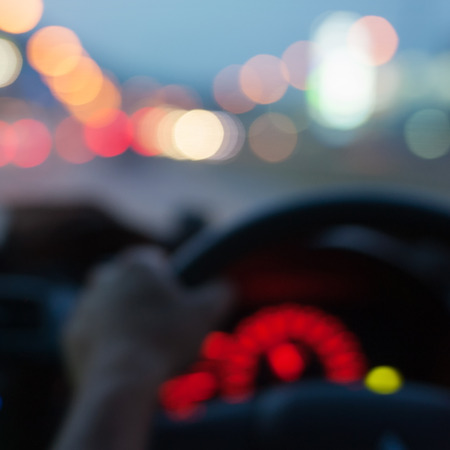Inside car with bokeh lights from traffic on night time.  Blur image