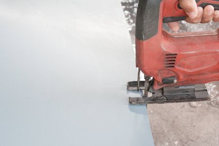 Close-up process of cutting steel plate with jigsawの写真素材