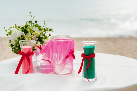Sand ceremony on wedding, glass vases for bride and groom with on beachの写真素材