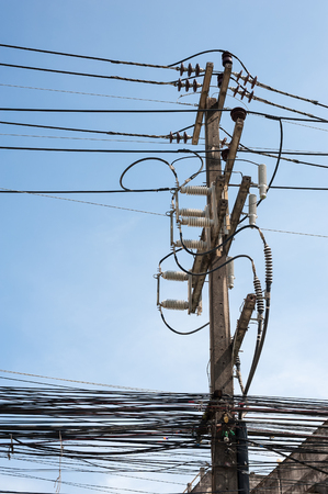 Power lines and insulators with blue skyの写真素材