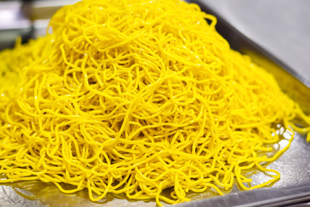 Yellow noodles on the marketの写真素材