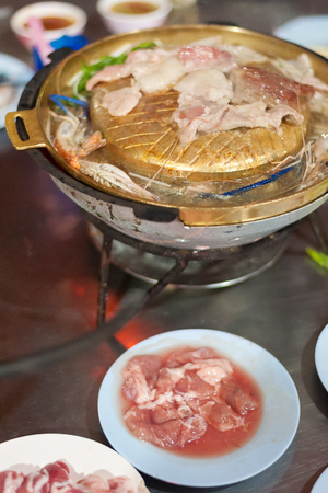 Raw food on the stove brass charcoal grillの写真素材