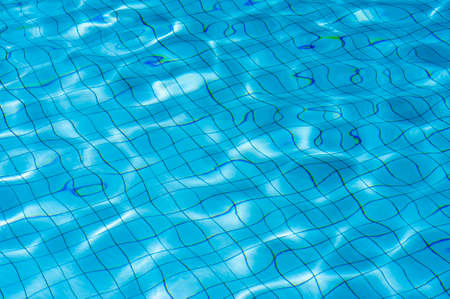 Light Blue swimming pool rippled water texture reflectionの写真素材