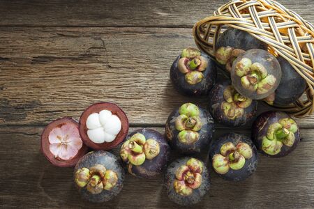 Mangosteen fruit on wood table with top viewの写真素材