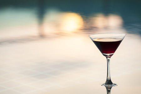 Cocktail glasses at pool with  sunsetの写真素材