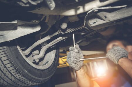 Mechanic repairing a car with process vintage style.の写真素材