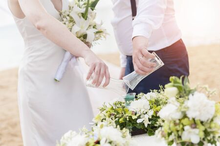 Blending of the sands at wedding ceremony on the beachの写真素材