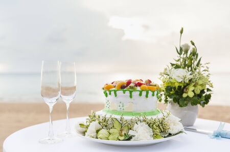 wedding cake and champagne wine glass on beachの写真素材