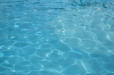 Light Blue swimming pool rippled water texture reflectionの写真素材