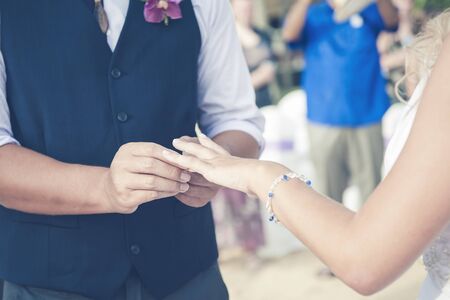 Groom Put the Wedding Ring on brideの写真素材