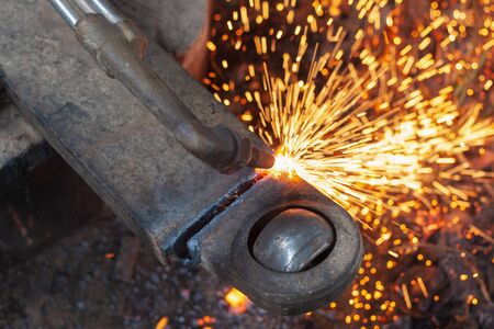 close up cutting old steel  with fire from gasの写真素材