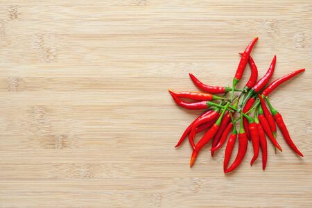 red chili peppers on  wooden background with copy spaceの写真素材