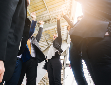 Business team joining hands together standing Hand Raised successful and congrats conceptの写真素材