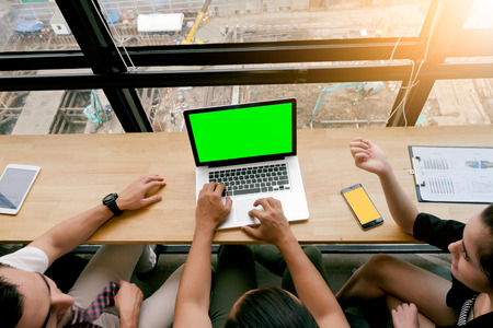 smart business partners using laptop at office meeting.construction site top view.focus on isolate green laptopの写真素材
