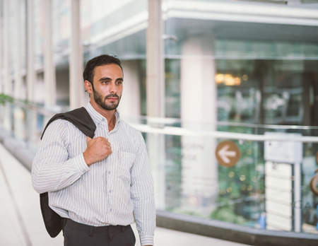 Portrait of handsome Asian businessman standing with formal suit. City background in an urban settingの写真素材