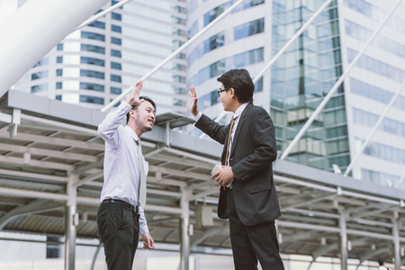 Business celebration for good teamwork with a high-fiveの写真素材